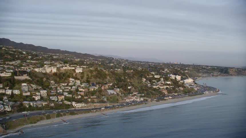 An aerial view of buildings lining a seacoast
