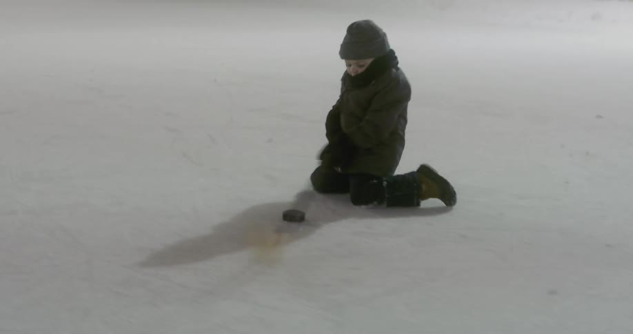 A child playing hockey on the ice