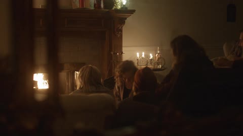 A family talks in front of the fire chimney on the night