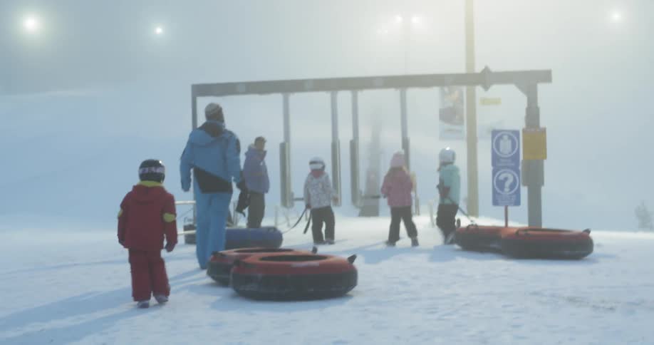 A family playing on the snow at the winter days