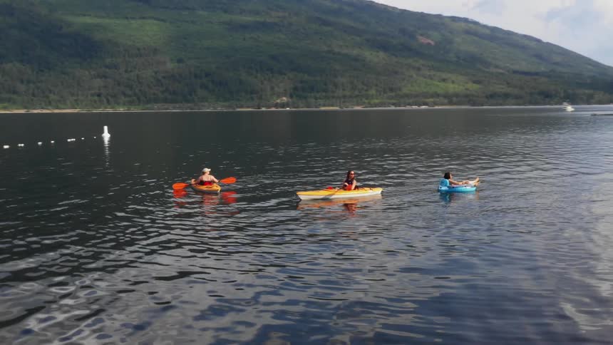 A group of people kayaking at the lake