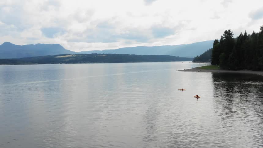 Two canoes travel in the lake