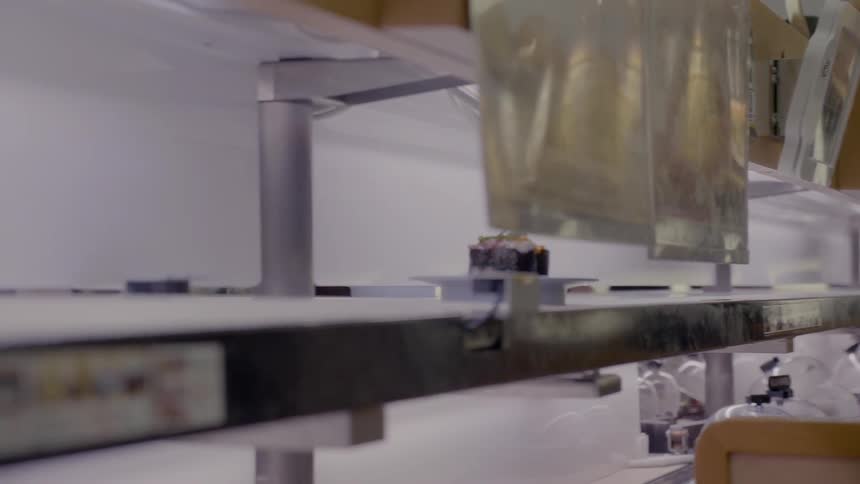 A dessert rolls down the conveyor belt