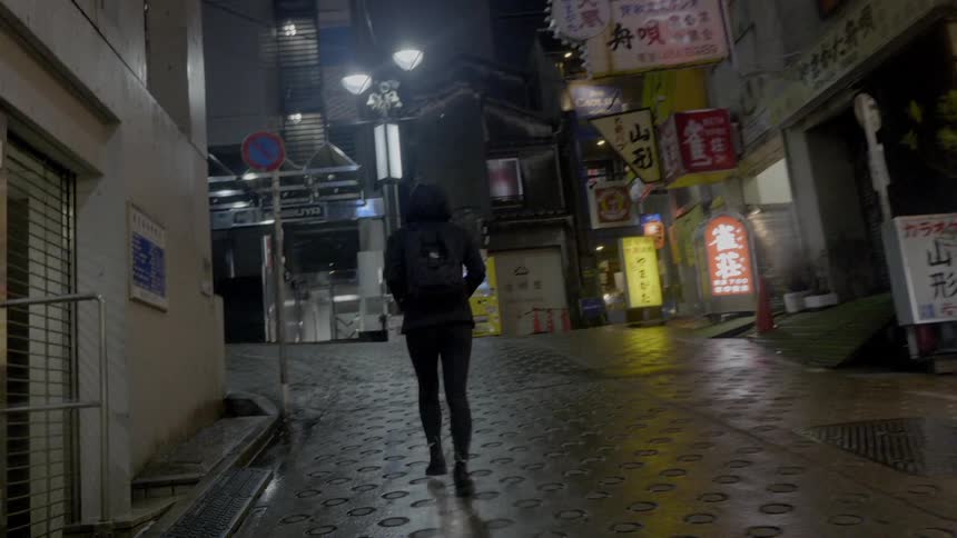 A woman is walking through a city