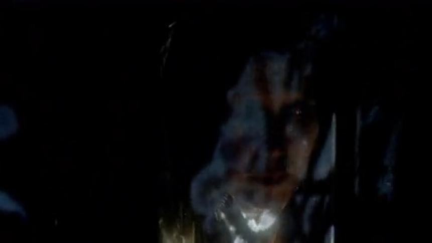 Abstract projections show on a womans face as she turns her head