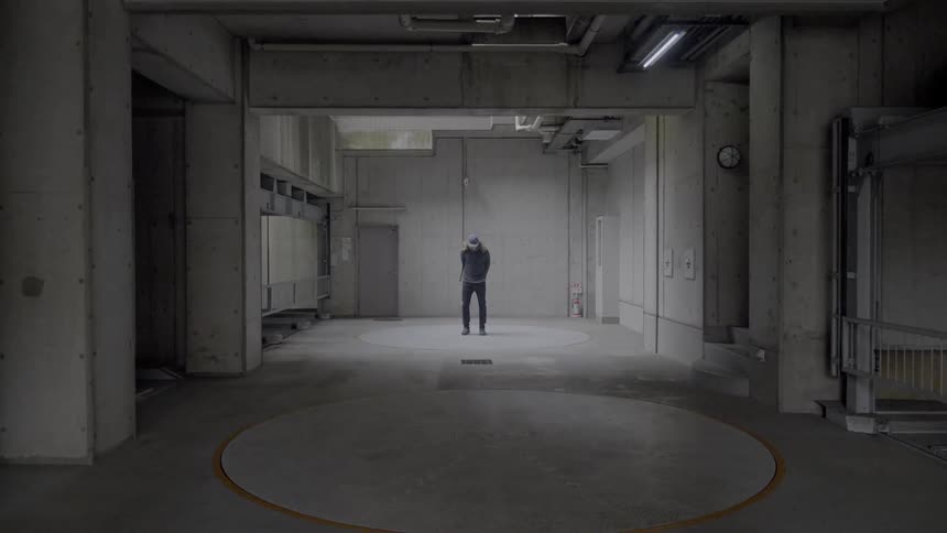A man stands in an empty factory