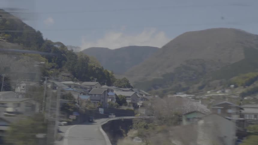 Homes occupy slope and valley between mountains