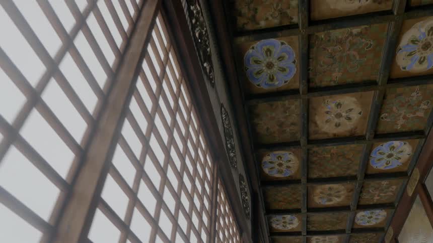 Painted tiles in a hallway ceiling above windows