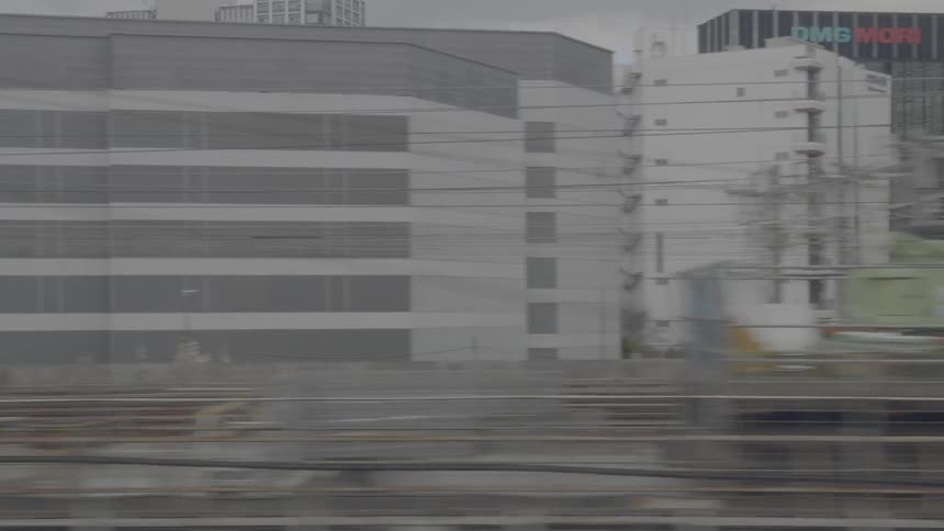Train tracks with buildings in the background