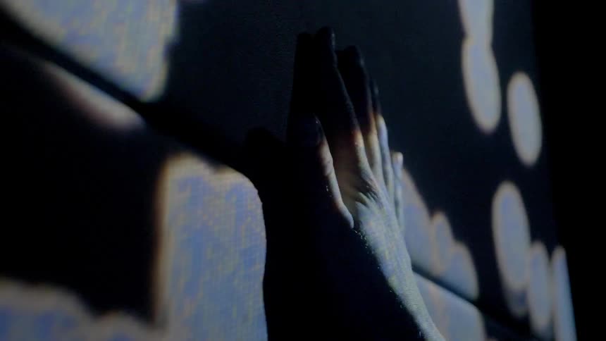 A person touches a wall