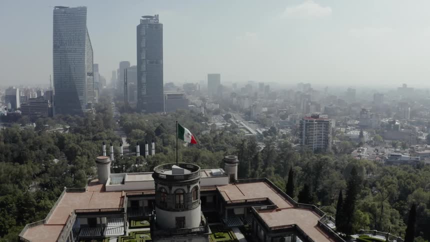An aerial footage of a campus and city skyline