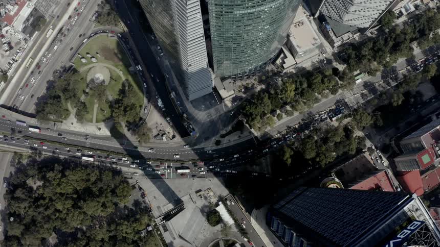 An aerial view of cars driving on a city street in heavy traffic