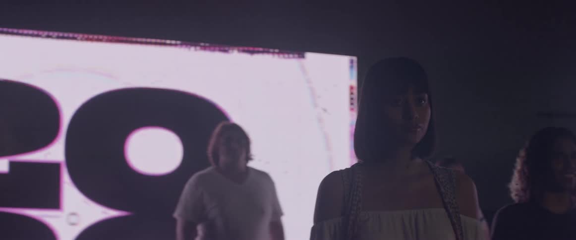 A group of woman standing in front of a big screen