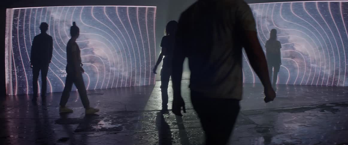 People walk over to the screens and stand together
