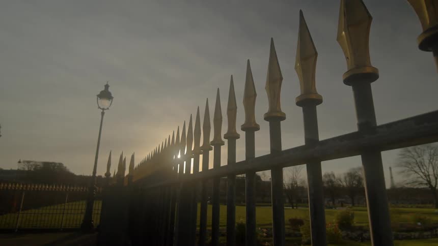 Long line of elaborate fence surrounds wide estate
