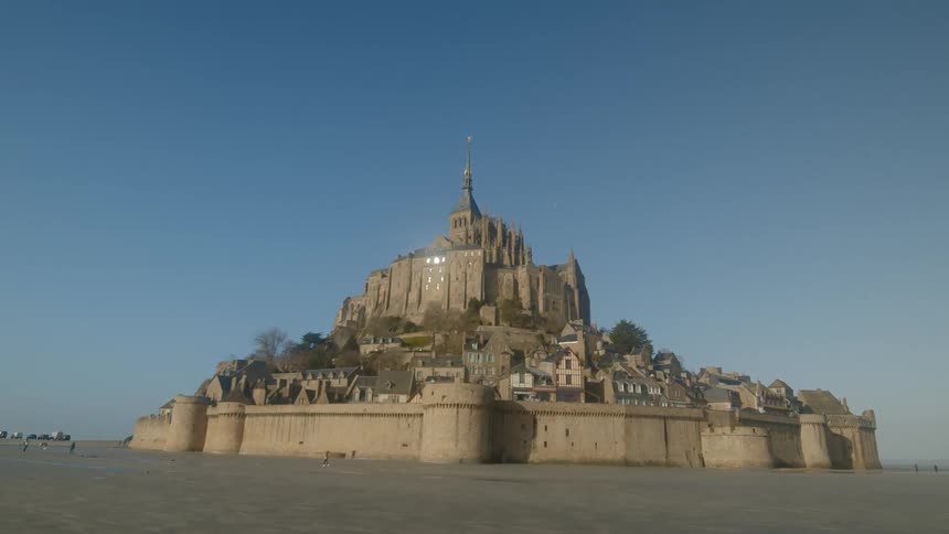 The castle sits behind the wall above the small city