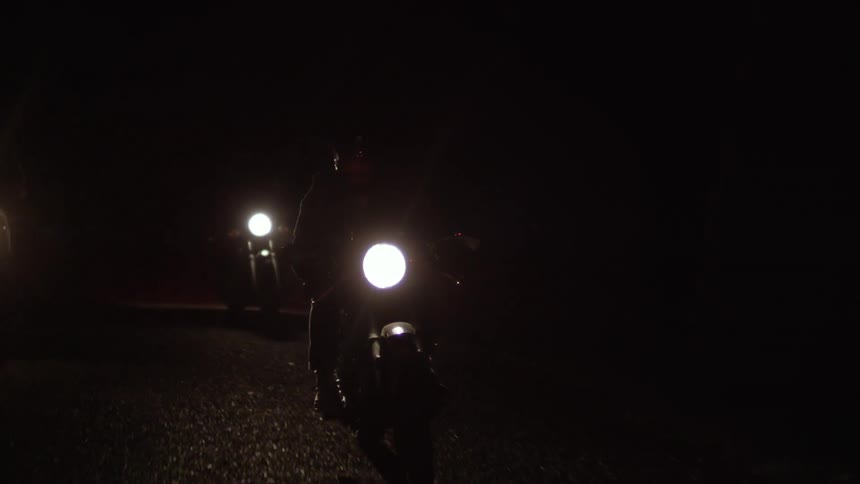People riding motorcycles at night