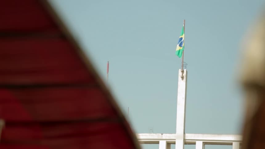 A green and yellow flag blowing in the breeze