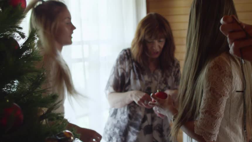 A family decorating a christmas tree