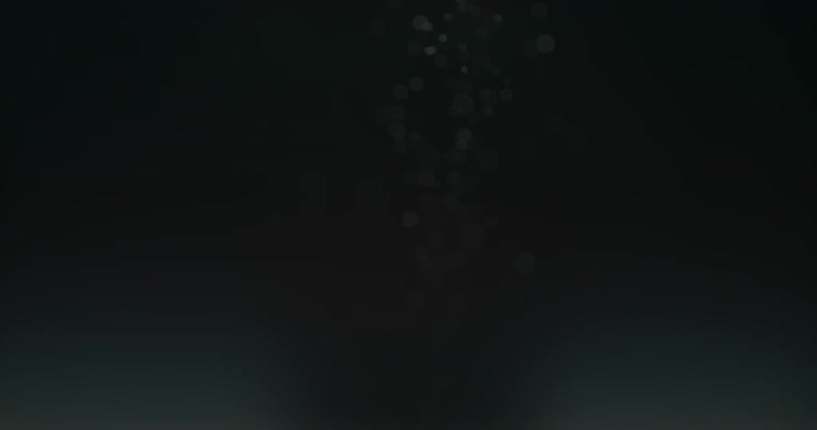 Bubbles rise up in a dark liquid
