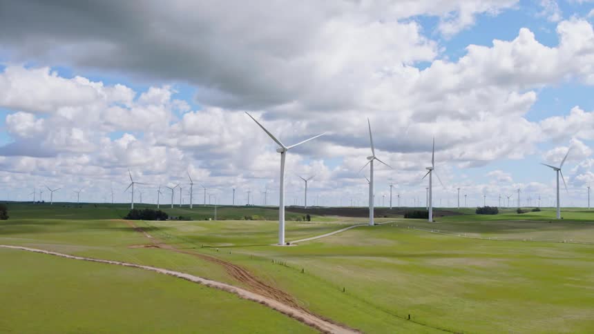 Windmills rotate slowly on a wind farm