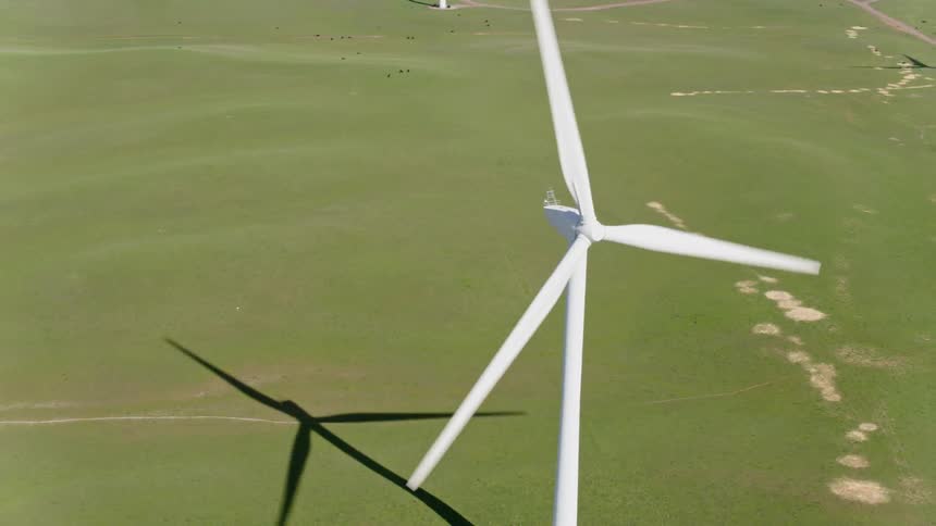A wind turbine spins in a field