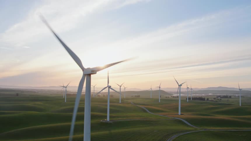 A scenery of a windmill in the middle of grassland