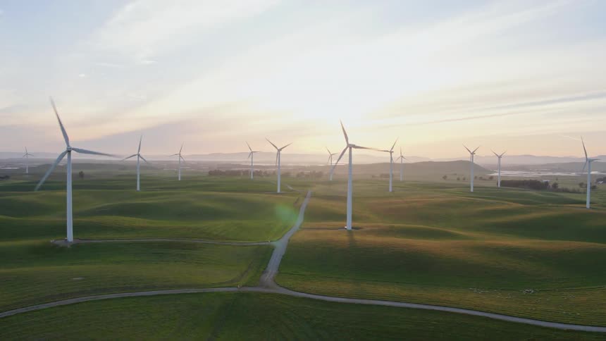 An aerial view of wind turbines in a rural field