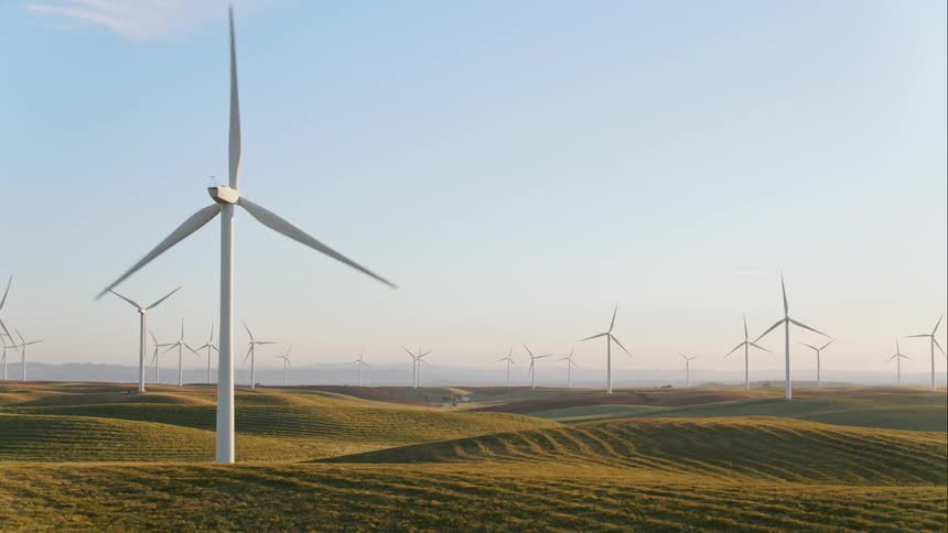Wind turbines being spun by the wind on a wind farm