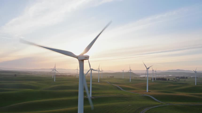 A scenery of a windmill at sunset