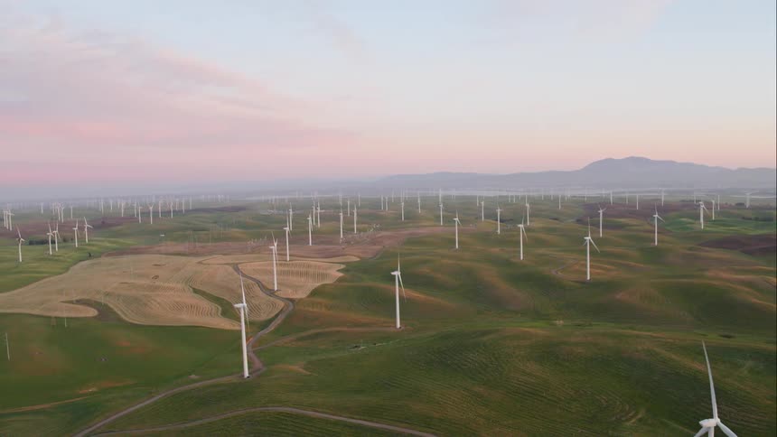 Rolling hills are dotted with wind turbines