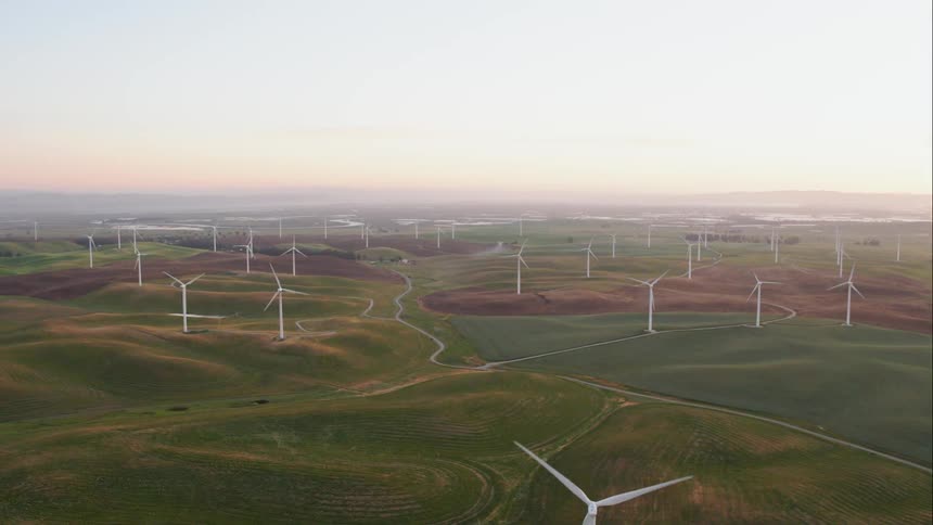 Wind turbines spinning on a field