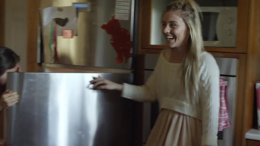 A family in a kitchen and dining room