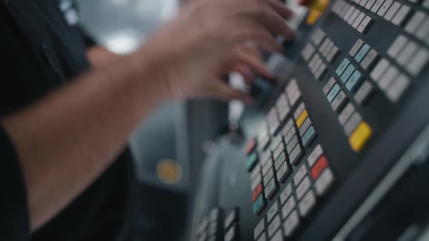 Man hits button on large complex looking console