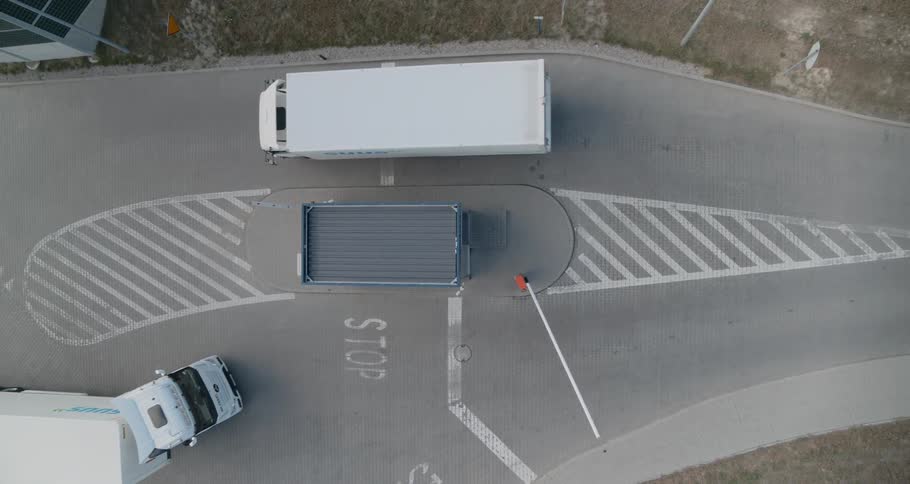Panel truck and semi pass as one enters and one leave truck weigh station
