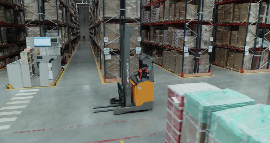 Men operating forklifts in a warehouse
