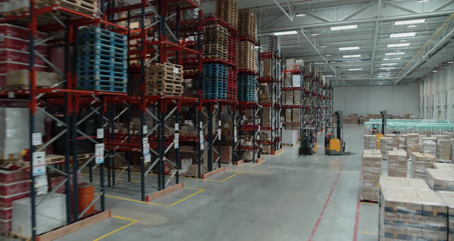 People operating forklifts in a warehouse