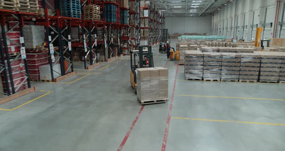 Multiple run forklifts around the interior of a warehouse