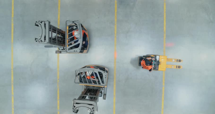 People on forklifts all drive together to talk