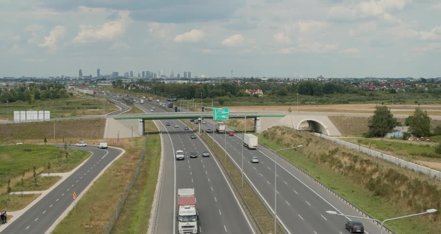 The highway is busy with many vehicles traveling