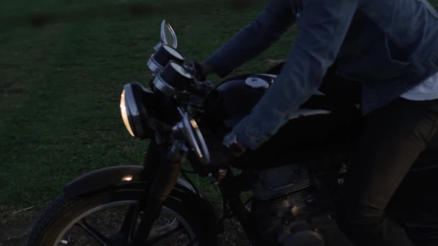 A man riding a motorcycle comes to a stop