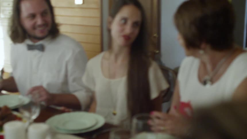 A family talking and laughing at a table