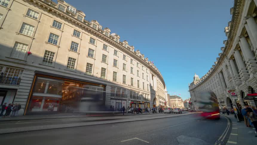 A busy city street with buildings and the sky in the background