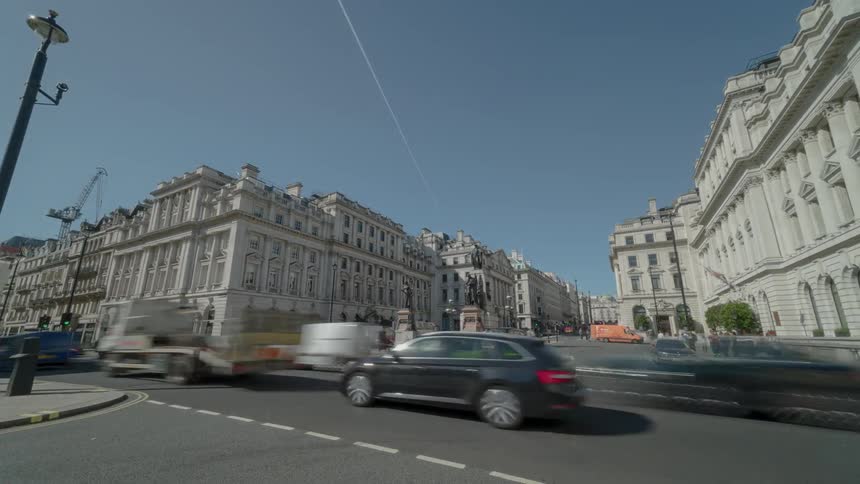 A city street with vehicles and buildings in the background