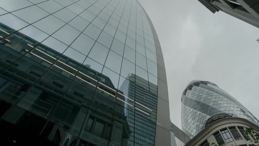 Buildings with the sky and clouds moving above