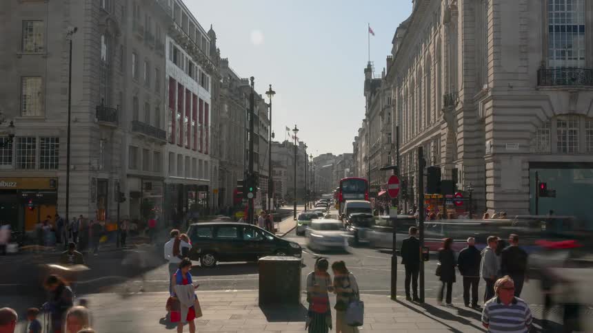 Buses and people travel in the intersection of the city