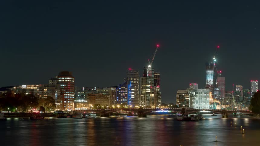 Time lapse of boats on the river thames at night