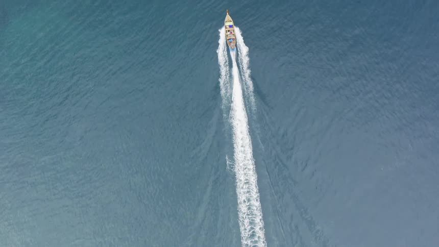 Aerial of a boat cruising in the middle of the ocean