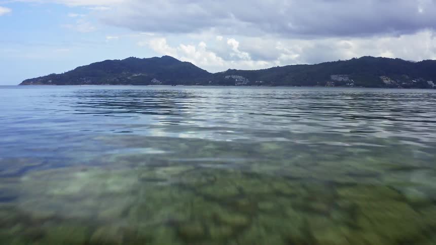 Buoys lay across the lake surface near the mountains
