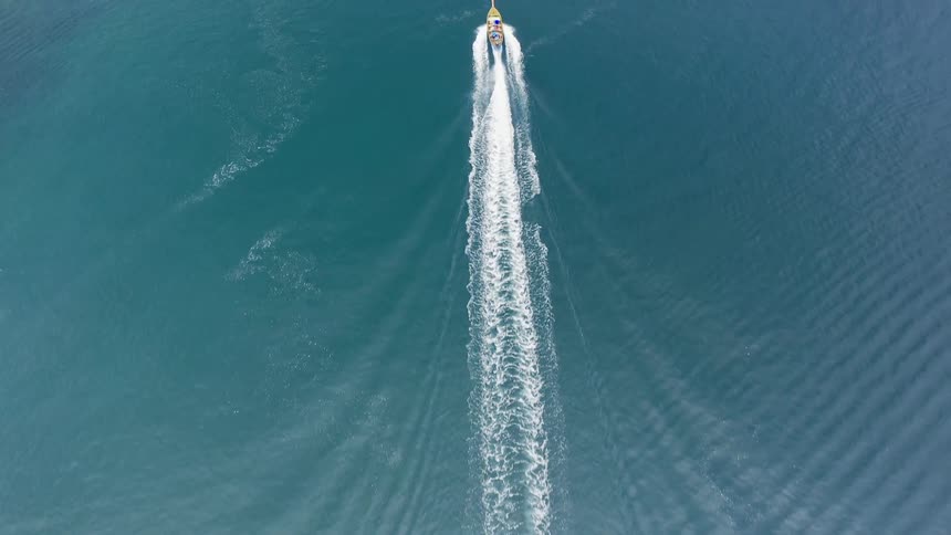 A boat creates a wake in the water